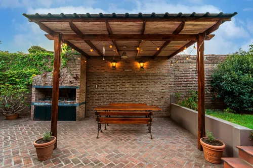 Open wooden pergola over a brick patio — illustrative stock photo, not an actual Las Vegas installation.